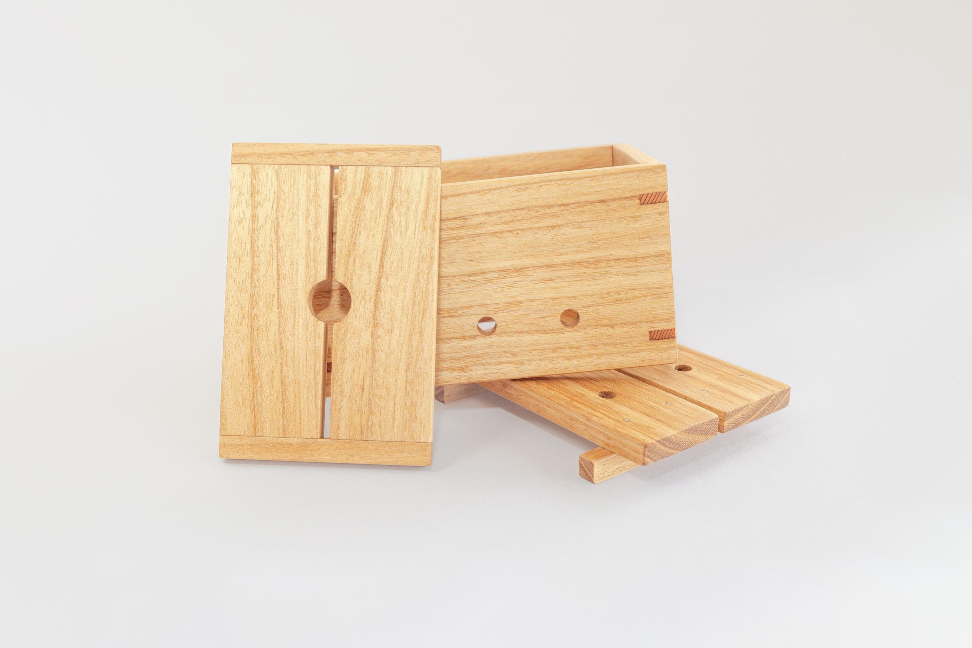 A product image showing the separate base, lid and body of a wooden tofu press by Tofu Press Australia. On a white background.