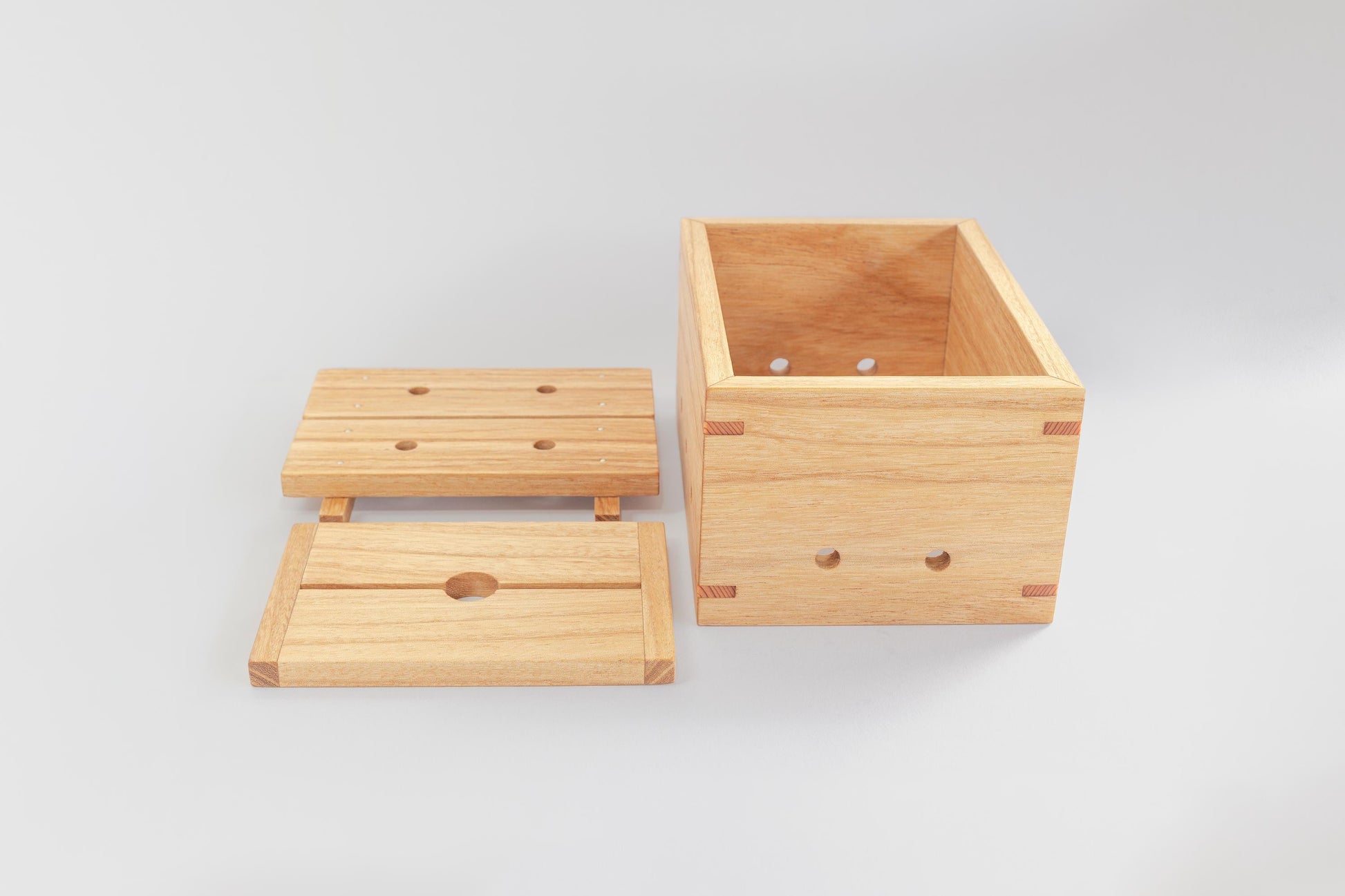 A wooden tofu press by Tofu Press Australia alongside the separate base and lid on a white background.