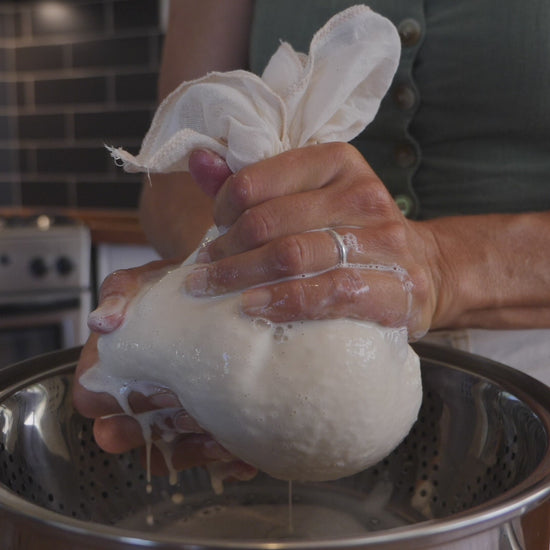 Video of tofu making process using a muslin cloth to strain soy milk.