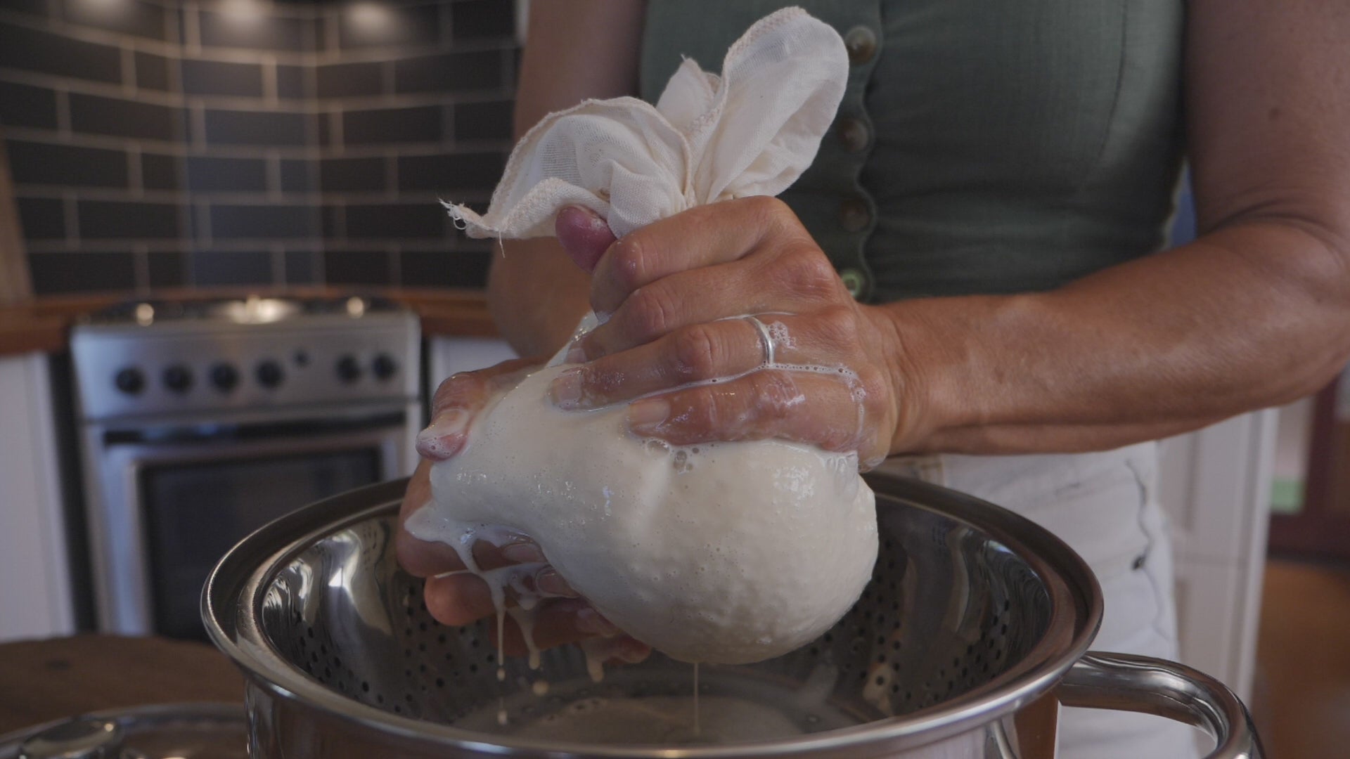 Video of tofu making process using a muslin cloth to strain soy milk.